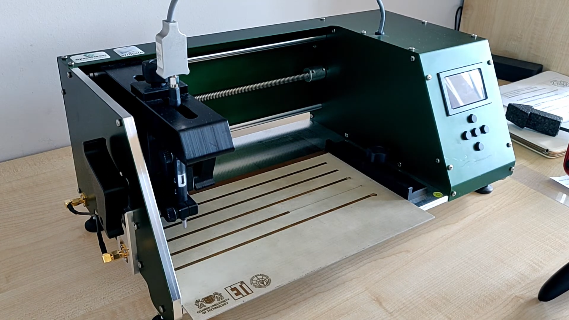 CNC engraving machine milling the Gdańsk University of Technology ETI logo
